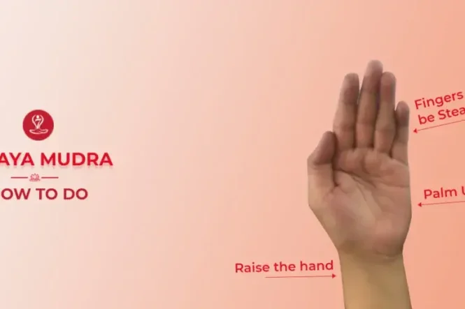 Person practicing Abhaya Mudra (Gesture of Fearlessness) during meditation in a peaceful yoga pose.