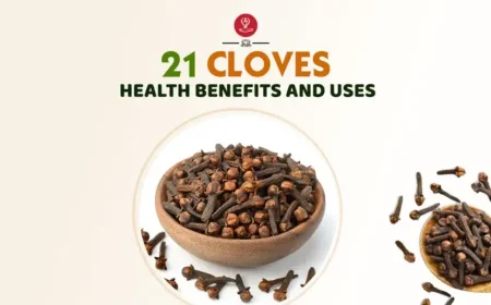 Whole cloves and clove powder on a wooden spoon