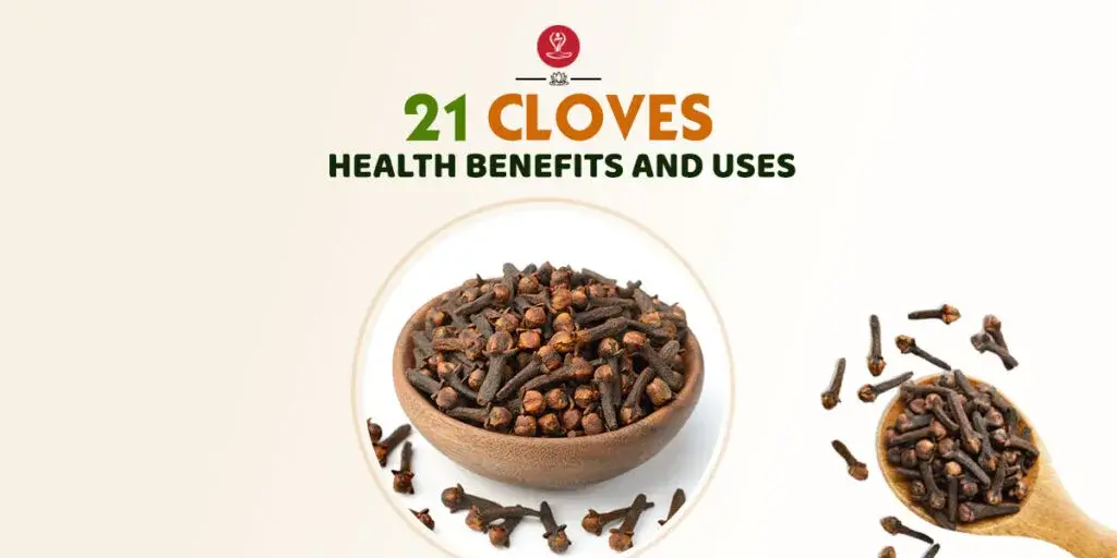 Whole cloves and clove powder on a wooden spoon