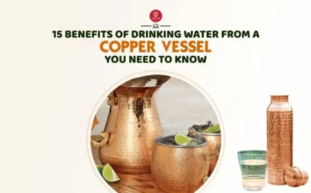 Copper water bottle beside a glass of water and healthy fruits