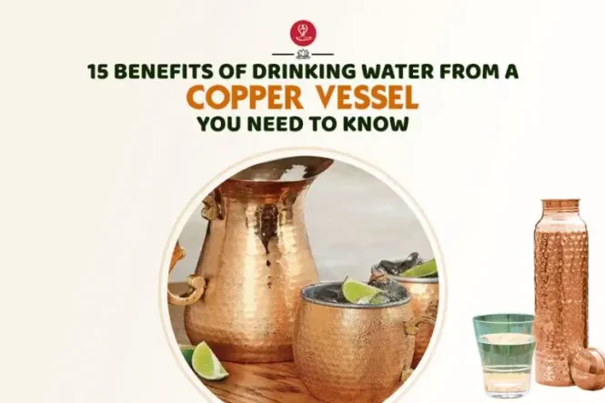 Copper water bottle beside a glass of water and healthy fruits