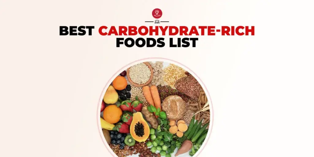 A colorful flat lay of carbohydrate-rich foods including whole grains, sweet potatoes, bananas, legumes, and oats arranged on a wooden table to highlight healthy, energy-boosting foods.